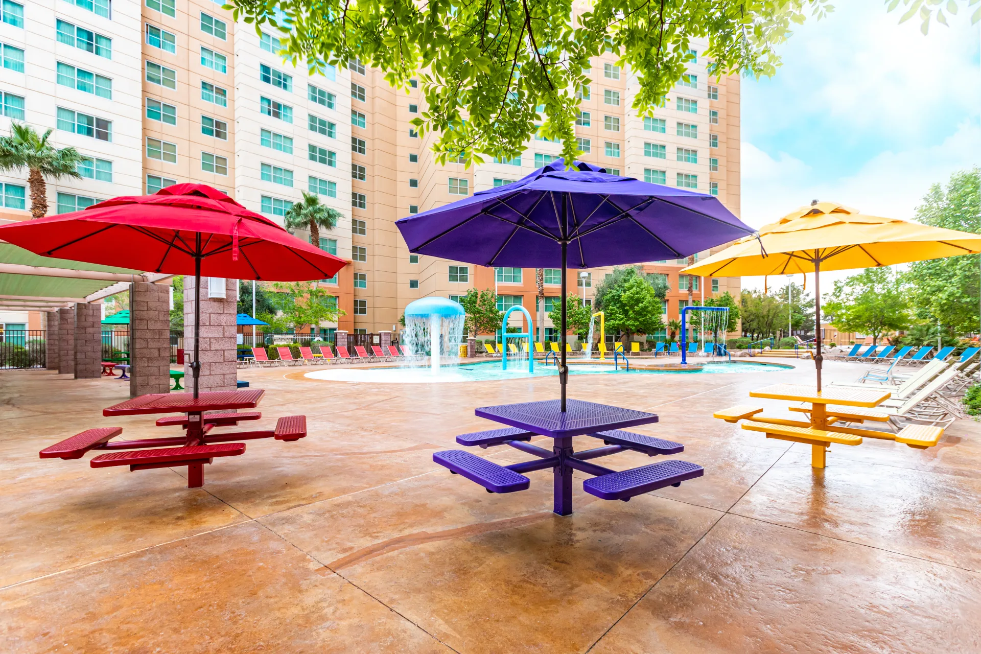 Colorful umbrellas and group picnic seating on the Grandview Las Vegas pool deck